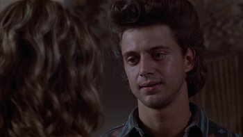Movie still from “Flesh and Bone” (1993), directed by Steve Kloves – A young man looking at a young woman in front of a mirror; Close Up shot, Over the shoulder angle