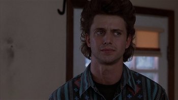 Movie still from “Flesh and Bone” (1993), directed by Steve Kloves – A young man with long hair and a mustache; Close Up shot, Over the shoulder angle