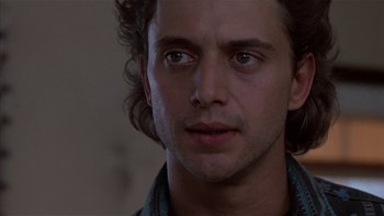 Movie still from “Flesh and Bone” (1993), directed by Steve Kloves – A man's face in a dark room; Close Up shot, Low angle