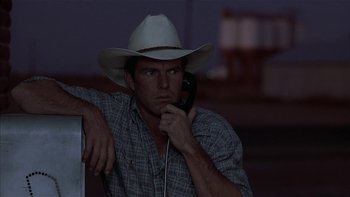 Movie still from “Flesh and Bone” (1993), directed by Steve Kloves – A man wearing a cowboy hat while talking on a phone; Close Up shot, Low angle