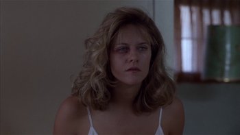 Movie still from “Flesh and Bone” (1993), directed by Steve Kloves – A woman with long blonde hair stares into the camera; Close Up shot, Low angle