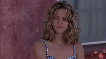 Movie still from “Flesh and Bone” (1993), directed by Steve Kloves – A woman with long blonde hair wearing a checkered top; Close Up shot, Low angle