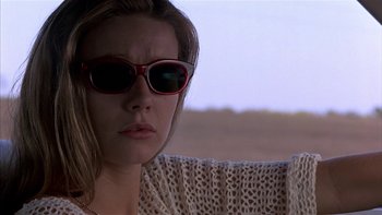 Movie still from “Flesh and Bone” (1993), directed by Steve Kloves – A person wearing sunglasses and a sweater; Close Up shot, Low angle