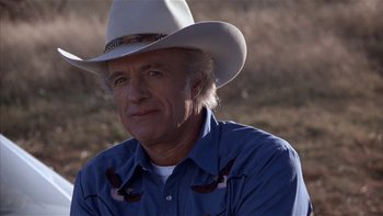 Movie still from “Flesh and Bone” (1993), directed by Steve Kloves – An older man wearing a cowboy hat in a field; Close Up shot, Low angle
