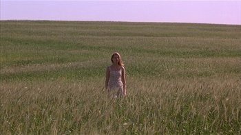 Movie still from “Flesh and Bone” (1993), directed by Steve Kloves – A woman standing in the middle of an open field; Extreme Wide shot, Low angle