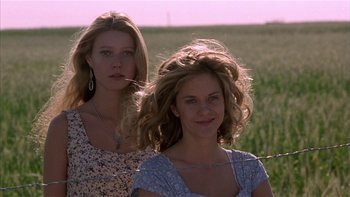 Movie still from “Flesh and Bone” (1993), directed by Steve Kloves – Two women standing next to each other in a field; Close Up shot, Low angle