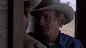 Movie still from “Flesh and Bone” (1993), directed by Steve Kloves – A man wearing a cowboy hat talking to another man; Close Up shot, Over the shoulder angle