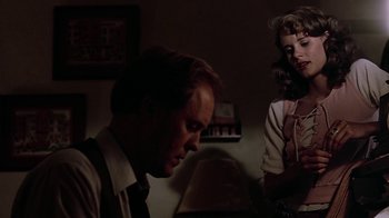 Movie still from “Footloose” (1984), directed by Herbert Ross – A man and a woman in a dark room; Medium shot, Over the shoulder angle