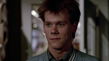 Movie still from “Footloose” (1984), directed by Herbert Ross – A person wearing a shirt; Close Up shot, Low angle