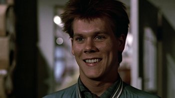 Movie still from “Footloose” (1984), directed by Herbert Ross – A person smiling; Close Up shot, Low angle