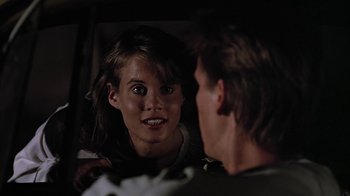 Movie still from “Footloose” (1984), directed by Herbert Ross – A woman looking at a man in the mirror; Close Up shot, Over the shoulder angle