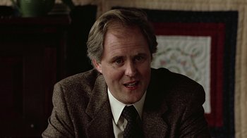 Movie still from “Footloose” (1984), directed by Herbert Ross – A person wearing a suit and tie; Close Up shot, Over the shoulder angle