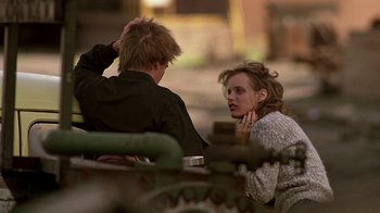 Movie still from “Footloose” (1984), directed by Herbert Ross – A man and a woman are sitting on a bench; Medium shot, Over the shoulder angle