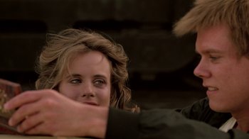 Movie still from “Footloose” (1984), directed by Herbert Ross – A woman's face and a man's arm; Close Up shot, Over the shoulder angle