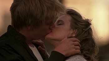 Movie still from “Footloose” (1984), directed by Herbert Ross – A man and a woman kissing each other; Close Up shot, Low angle
