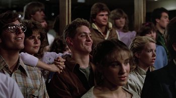 Movie still from “Footloose” (1984), directed by Herbert Ross – A group of young people sitting in a room together; Close Up shot, Over the shoulder angle