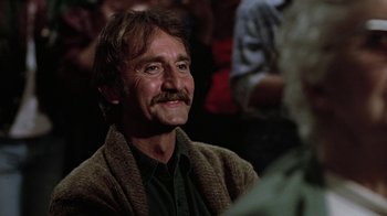 Movie still from “Footloose” (1984), directed by Herbert Ross – A person sitting in a room; Close Up shot, Over the shoulder angle