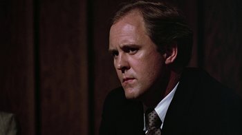 Movie still from “Footloose” (1984), directed by Herbert Ross – A person wearing a suit and tie; Close Up shot, Low angle