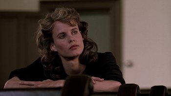 Movie still from “Footloose” (1984), directed by Herbert Ross – A woman sitting in front of a window with her arms crossed; Close Up shot, Over the shoulder angle