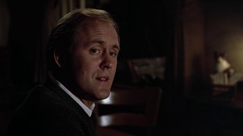 Movie still from “Footloose” (1984), directed by Herbert Ross – A person sitting in a chair; Close Up shot, Low angle