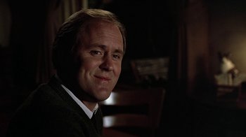 Movie still from “Footloose” (1984), directed by Herbert Ross – A person sitting in a chair; Close Up shot, Over the shoulder angle