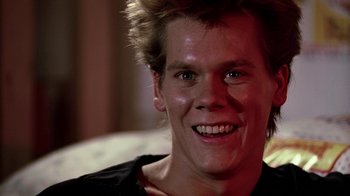 Movie still from “Footloose” (1984), directed by Herbert Ross – A person with a smile on their face; Close Up shot, Low angle