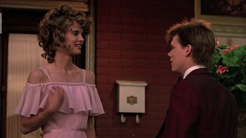 Movie still from “Footloose” (1984), directed by Herbert Ross – A young man and a young woman talking to each other; Medium shot, Over the shoulder angle