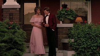 Movie still from “Footloose” (1984), directed by Herbert Ross – A man and a woman standing next to each other; Medium shot, Low angle