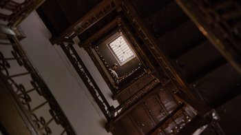 Movie still from “For Colored Girls” (2010), directed by Tyler Perry – Looking up at a clock on the wall of a staircase; Extreme Wide shot, Low angle
