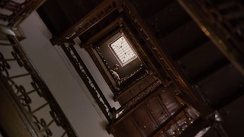 Movie still from “For Colored Girls” (2010), directed by Tyler Perry – Looking up at a clock on the wall of a staircase; Extreme Wide shot, Low angle