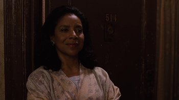 Movie still from “For Colored Girls” (2010), directed by Tyler Perry – A woman standing in front of a door in a room; Close Up shot, Low angle
