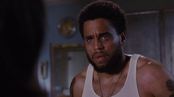 Movie still from “For Colored Girls” (2010), directed by Tyler Perry – A person wearing a tank top; Close Up shot, Over the shoulder angle