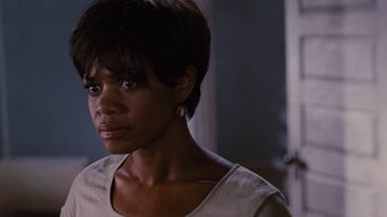 Movie still from “For Colored Girls” (2010), directed by Tyler Perry – A person with short black hair; Close Up shot, Over the shoulder angle