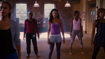 Movie still from “For Colored Girls” (2010), directed by Tyler Perry – A group of people standing in a room; Wide shot, Low angle