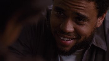 Movie still from “For Colored Girls” (2010), directed by Tyler Perry – A man smiling for the camera; Close Up shot, Over the shoulder angle