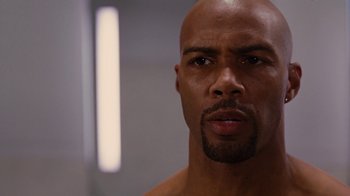 Movie still from “For Colored Girls” (2010), directed by Tyler Perry – A man with a beard is looking at the camera; Close Up shot, Low angle