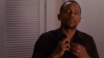 Movie still from “For Colored Girls” (2010), directed by Tyler Perry – A person wearing a black shirt; Close Up shot, Over the shoulder angle