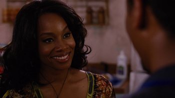 Movie still from “For Colored Girls” (2010), directed by Tyler Perry – A woman that is smiling for the camera; Close Up shot, Over the shoulder angle