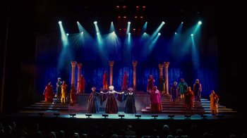 Movie still from “For Colored Girls” (2010), directed by Tyler Perry – A group of people standing on top of a stage under lights; Extreme Wide shot, High angle