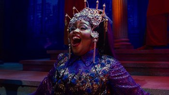 Movie still from “For Colored Girls” (2010), directed by Tyler Perry – A woman in a purple dress with a crown on her head; Medium shot, Low angle