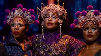 Movie still from “For Colored Girls” (2010), directed by Tyler Perry – A woman in a purple and gold outfit with purple and pink headpieces; Close Up shot, Low angle