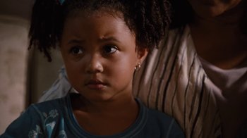 Movie still from “For Colored Girls” (2010), directed by Tyler Perry – A little girl sitting in a chair looking at the camera; Close Up shot, High angle