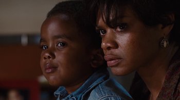 Movie still from “For Colored Girls” (2010), directed by Tyler Perry – A woman and a boy are looking at the camera; Close Up shot, Low angle