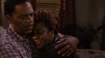 Movie still from “For Colored Girls” (2010), directed by Tyler Perry – A man and a woman hugging in a living room; Close Up shot, High angle