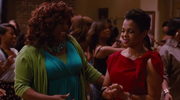 Movie still from “For Colored Girls” (2010), directed by Tyler Perry – Two women are dancing together at a party; Medium shot, High angle
