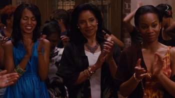 Movie still from “For Colored Girls” (2010), directed by Tyler Perry – A woman clapping her hands in a crowd of people; Medium shot, Over the shoulder angle