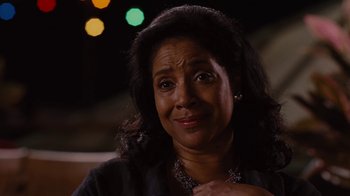 Movie still from “For Colored Girls” (2010), directed by Tyler Perry – An older woman is smiling for the camera; Close Up shot, Over the shoulder angle