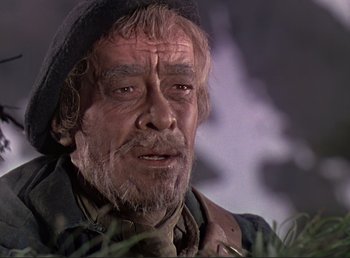 Movie still from “For Whom the Bell Tolls” (1943), directed by Sam Wood – An old man with a beard and a hat is looking at the camera; Close Up shot, Low angle