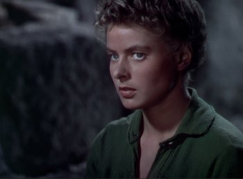Movie still from “For Whom the Bell Tolls” (1943), directed by Sam Wood – A woman with a green shirt is looking into the distance; Close Up shot, Over the shoulder angle