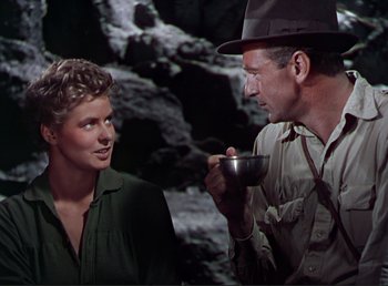 Movie still from “For Whom the Bell Tolls” (1943), directed by Sam Wood – A man and a woman are talking to each other; Medium shot, Over the shoulder angle
